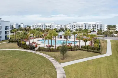 an aerial view of a resort with a pool and palm trees at Family Friendly 2 Bd Close to Disney @ Storey Lake 105 3161 in Kissimmee