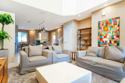 a living room with two couches and a table at Stunning 4Bd Close to Disney @ Magic Village 7614 in Orlando