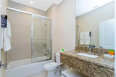 a bathroom with a toilet and a shower and a sink at Stunning 4Bd Close to Disney @ Magic Village 7614 in Orlando