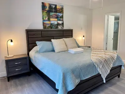 a bedroom with a bed with a blue comforter at Grand Family 3BR Condo Apartment near Disney Parks in Kissimmee
