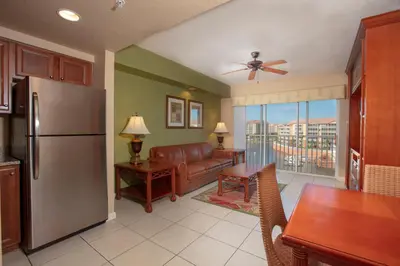 a kitchen and living room with a refrigerator and a couch at Westgate Town Center Resort in Orlando