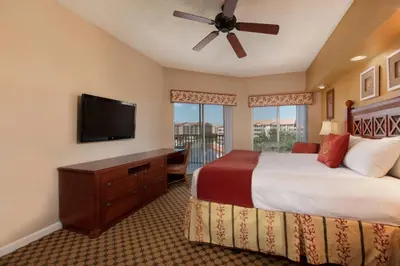 a bedroom with a bed and a flat screen tv at Westgate Town Center Resort in Orlando