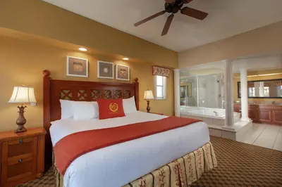 a bedroom with a large bed and a bathroom at Westgate Town Center Resort in Orlando