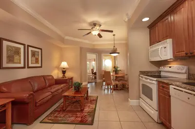 a living room with a couch and a kitchen at Westgate Town Center Resort in Orlando