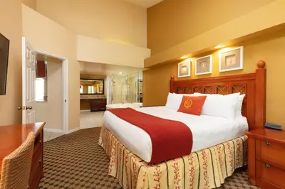 a bedroom with a large bed and a bathroom at Westgate Vacation Villas Resort in Orlando