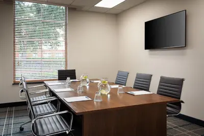 a conference room with a large wooden table and chairs at Four Points by Sheraton Orlando Convention Center in Orlando