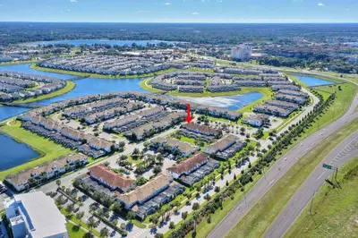 an aerial view of a subdivision of houses next to a river at Refurbished! Lazy Life At Storey Lake By Shine Villas #901 in Kissimmee
