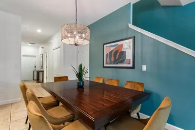 a dining room with a wooden table and chairs at Refurbished! Lazy Life At Storey Lake By Shine Villas #901 in Kissimmee
