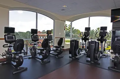 a gym with a row of chairs in front of windows at Westgate Lakes Resort and Spa in Orlando