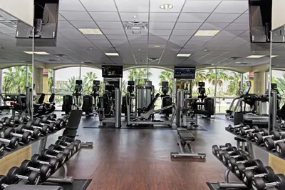 a gym with rows of treadmills and ellipticals at Westgate Lakes Resort and Spa in Orlando