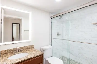 a bathroom with a toilet and a glass shower at Westgate Blue Tree Resort in Orlando