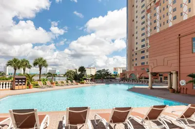 a swimming pool with lounge chairs and a hotel at Westgate Palace Hotel - Universal - I-Drive in Orlando