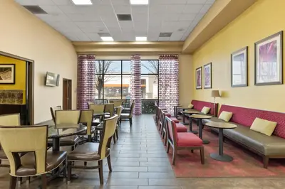 a waiting room with tables and chairs at Orlando Palms in Orlando