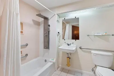 a bathroom with a toilet and a sink and a shower at Orlando Palms in Orlando