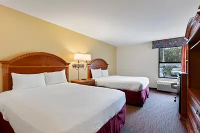 a hotel room with two beds and a window at Orlando Palms in Orlando