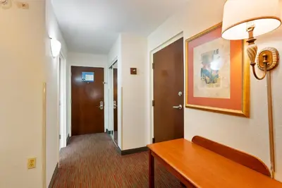 a hallway with a wooden table in a hotel room at Orlando Palms in Orlando