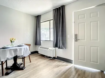 a dining room with a table and a window at Stayable Kissimmee West in Kissimmee