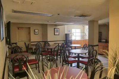 a restaurant with tables and chairs in a room at Destiny Palms Hotel Maingate West in Kissimmee
