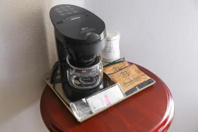 a coffee maker on top of a table at Destiny Palms Hotel Maingate West in Kissimmee