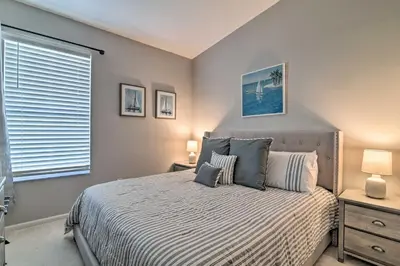 a bedroom with a bed and a window at 5 Mi to Disney World Retreat with Pool and Lanai! in Kissimmee