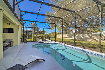 a swimming pool in a house with a glass roof at 5 Mi to Disney World Retreat with Pool and Lanai! in Kissimmee