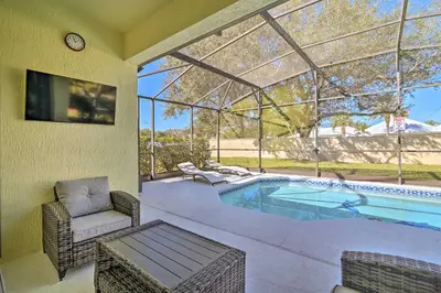 a swimming pool in a house with a conservatory at 5 Mi to Disney World Retreat with Pool and Lanai! in Kissimmee
