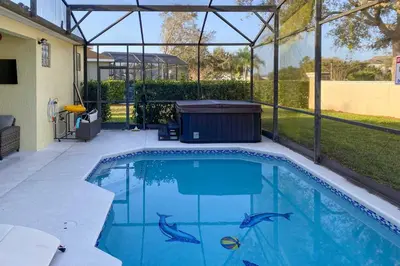 a swimming pool with dolphins painted on it at 5 Mi to Disney World Retreat with Pool and Lanai! in Kissimmee