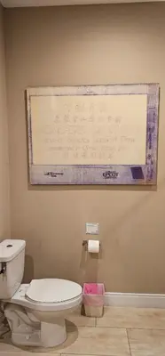 a sign on the wall of a bathroom with a toilet at Magic Village 4 Bedroom! Welcome Home! in Orlando