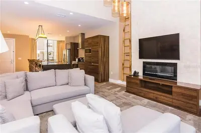 a living room with a white couch and a flat screen tv at Magic Village 4 Bedroom! Welcome Home! in Orlando