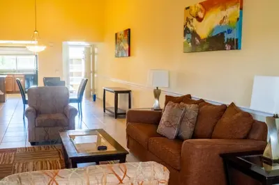 a living room with a couch and a chair at Silver Lake Resort in Orlando