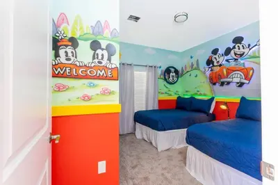two beds in a room with a hello kitty bedroom at Wonderful 5 Bd Close to Disney @ Storey Lake Resort 2980 in Kissimmee