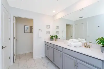 a white bathroom with a sink and a mirror at Wonderful 5 Bd Close to Disney @ Storey Lake Resort 2980 in Kissimmee