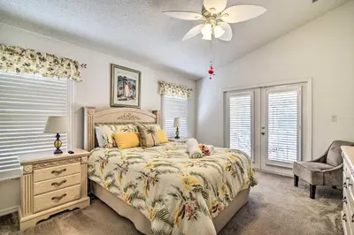 a bedroom with a bed and a ceiling fan at No Pet Fee! Snowbird Haven in Lake Worth Beach! in Orlando