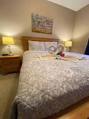 a bedroom with a bed with a bow on it at 3 bedroom Disney Condo Windsor Hills in Orlando