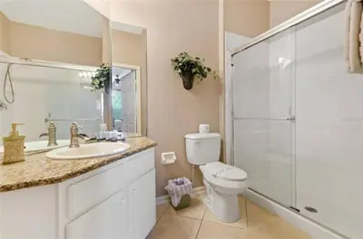 a bathroom with a toilet and a shower and a sink at 3 bedroom Disney Condo Windsor Hills in Orlando