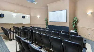a lecture room with black chairs and a screen at 3 bedroom Disney Condo Windsor Hills in Orlando