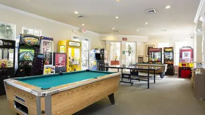 a room with a pool table and arcade games at Resort 5 Bed Private Pool & Spa, Game Room Home villa in Kissimmee