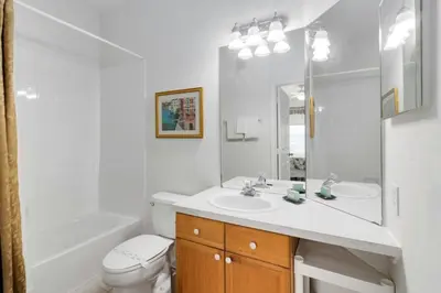 a white bathroom with a sink and a tub and a toilet at Amazing Resort 2 bed condo close to Disney condo in Kissimmee