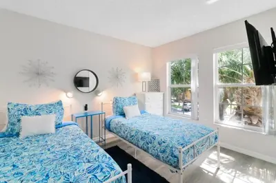 a bedroom with two beds and a window at Disney Area 4 bed 3,5 Bathroom Emerald Island townhouse in Kissimmee