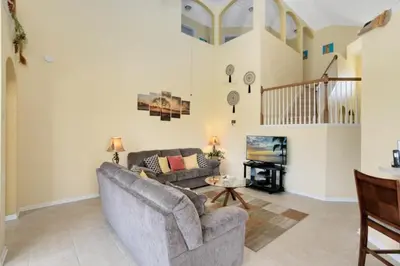 a living room with a couch and a table at Fantastic Resort 5BR House - South Facing Pool Spa villa in Kissimmee
