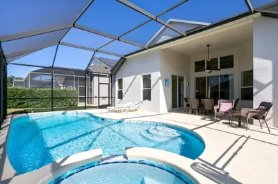 a swimming pool in the backyard of a house at Fantastic Resort 5BR House - South Facing Pool Spa villa in Kissimmee