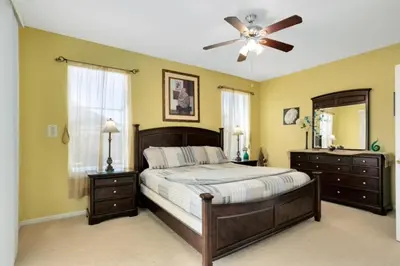 a bedroom with a bed and a ceiling fan at Fantastic Resort 5BR House - South Facing Pool Spa villa in Kissimmee