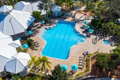 an overhead view of a swimming pool with umbrellas at 4 Bedroom 3 Bath South Facing Pool Spa Villa villa in Kissimmee