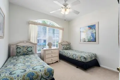a bedroom with two beds and a window at 4 Bedroom 3 Bath South Facing Pool Spa Villa villa in Kissimmee