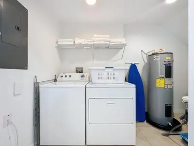 a laundry room with a washer and a refrigerator at Amazing Townhouse close to Disney 2 Bed 2,5 Bath townhouse in Kissimmee