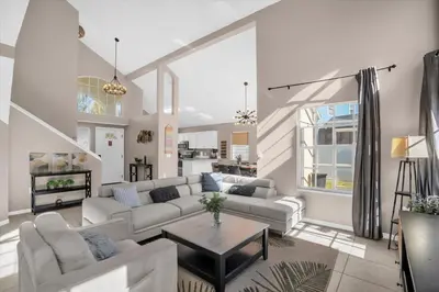 a living room with a couch and a table at Elegant Villa Pool Fun Game Room Near Disney in Kissimmee