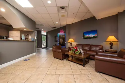 a waiting room with leather couches and a bar at Exclusive Ground-Floor Apartment in Orlando