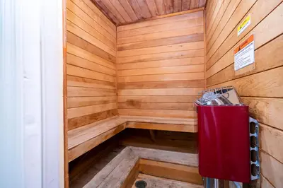 a wooden sauna with a red trash can in it at Beautiful, cozy and spacious Retreat near Disney in Kissimmee