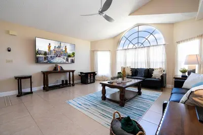 a living room with a couch and a table at Beautiful, cozy and spacious Retreat near Disney in Kissimmee