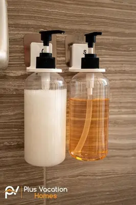 two bottles of soap sitting on top of a table at 8503 Themed 7BD Villa- Game room Poolspa in Kissimmee